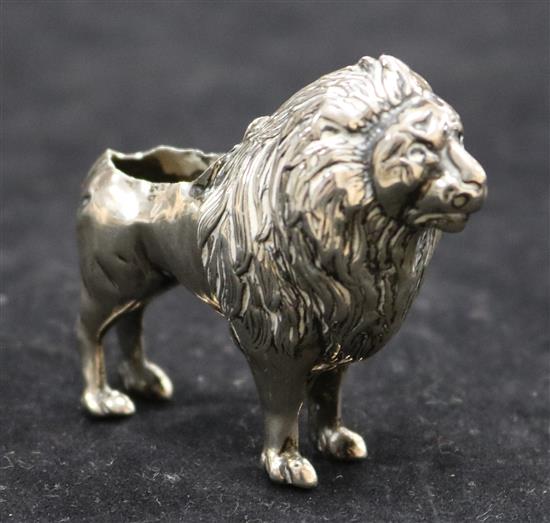 An Edwardian silver pincushion in the form of a standing lion (cushion and tail deficient),